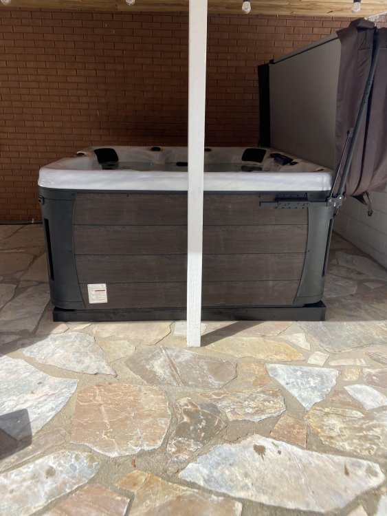 How to level a Jacuzzi brand hot tub on sloping concrete patio? Build